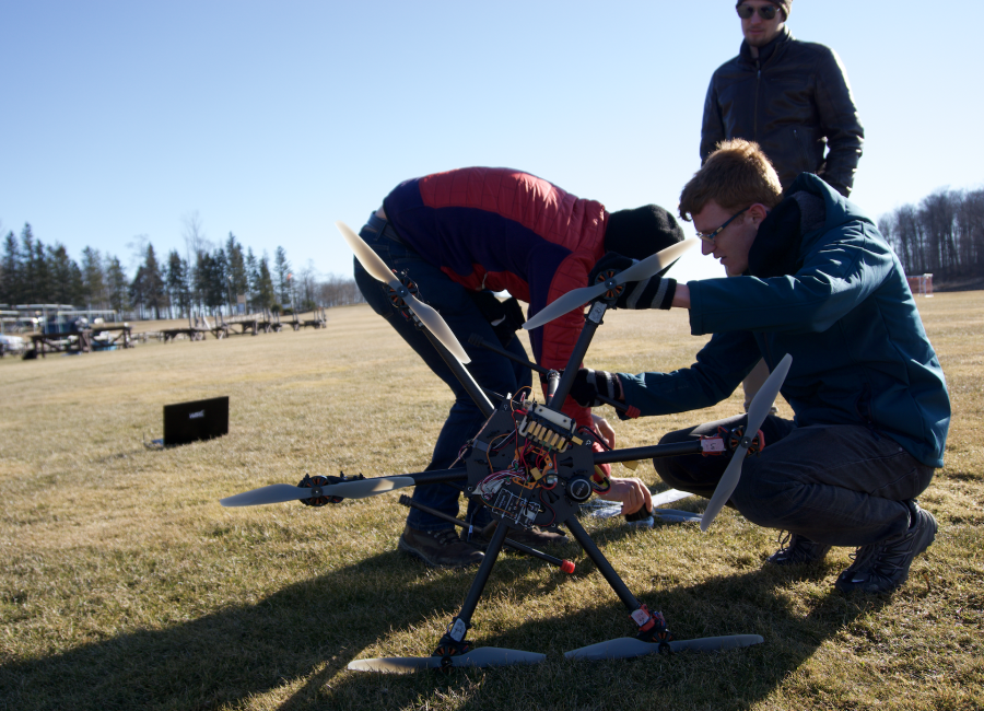 University of Waterloo Aerial Robotics Group members prepare the autonomous vehicle for a test flight